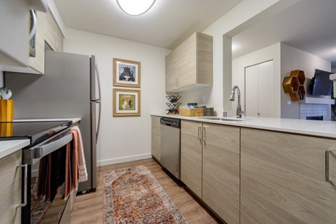 a kitchen with stainless steel appliances and wooden cabinets