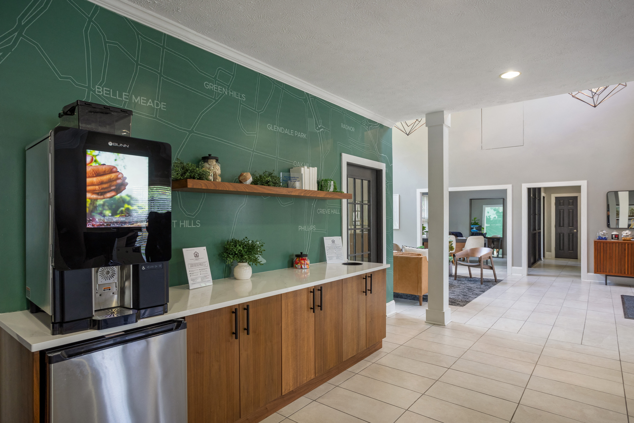 a kitchen with a coffee machine and a green wall