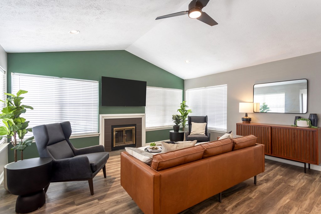 a living room with a couch and chairs and a fireplace