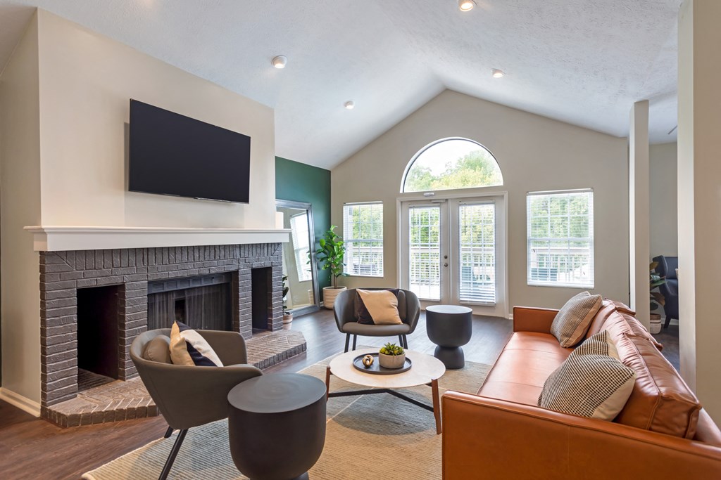 a living room with a fireplace and a tv above it