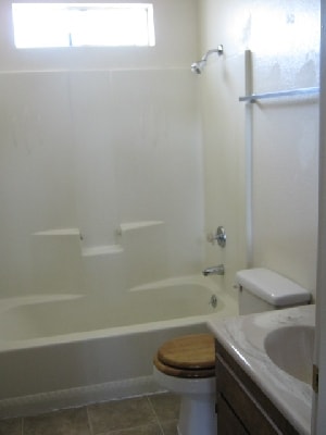 A white bathroom with a toilet and sink.