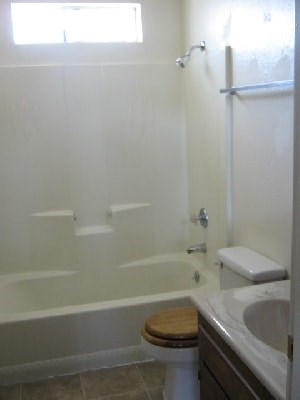 A white bathroom with a toilet and sink.