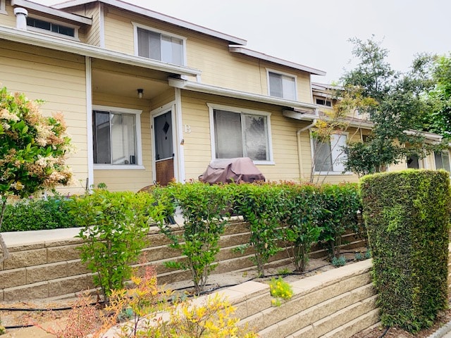 A house with a well-maintained garden in front.