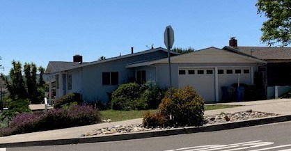 a white house with a stop sign in front of it