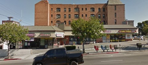 a truck parked on the street in front of a brick building
