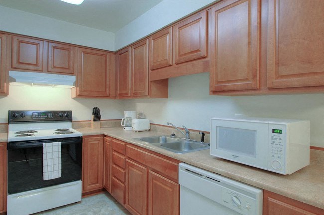 a kitchen with a stove microwave and a sink