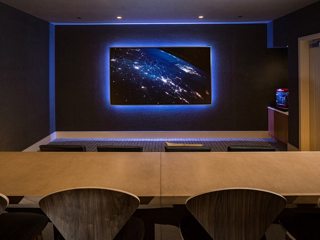 a conference room with a desk and a picture of the earth on the wall