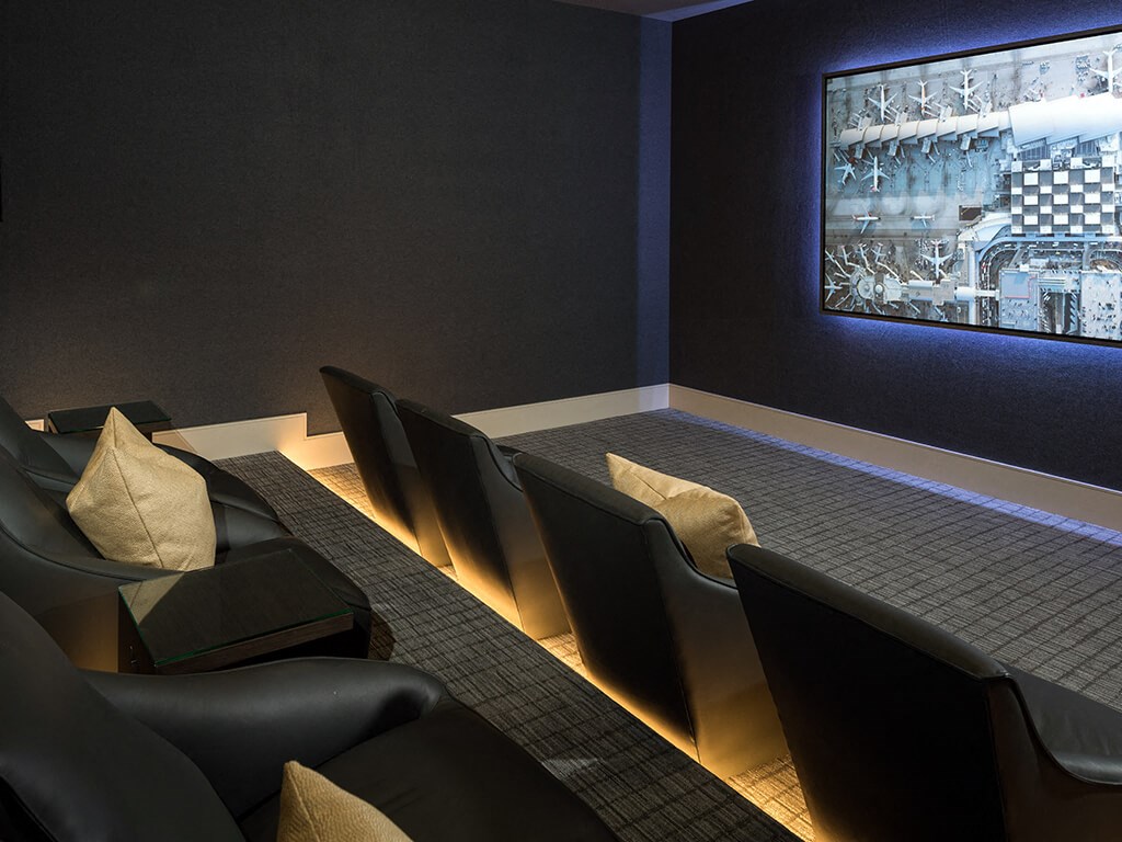 a conference room with chairs and a projector screen