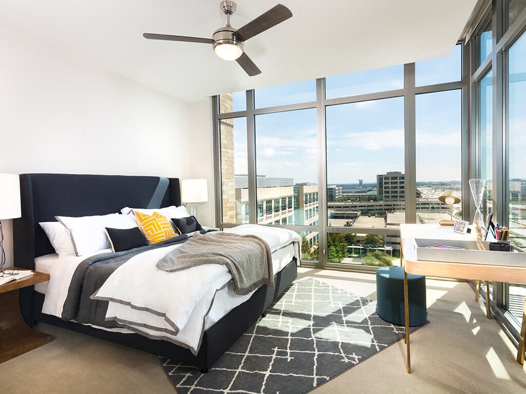 a bedroom with a bed and a view of the city