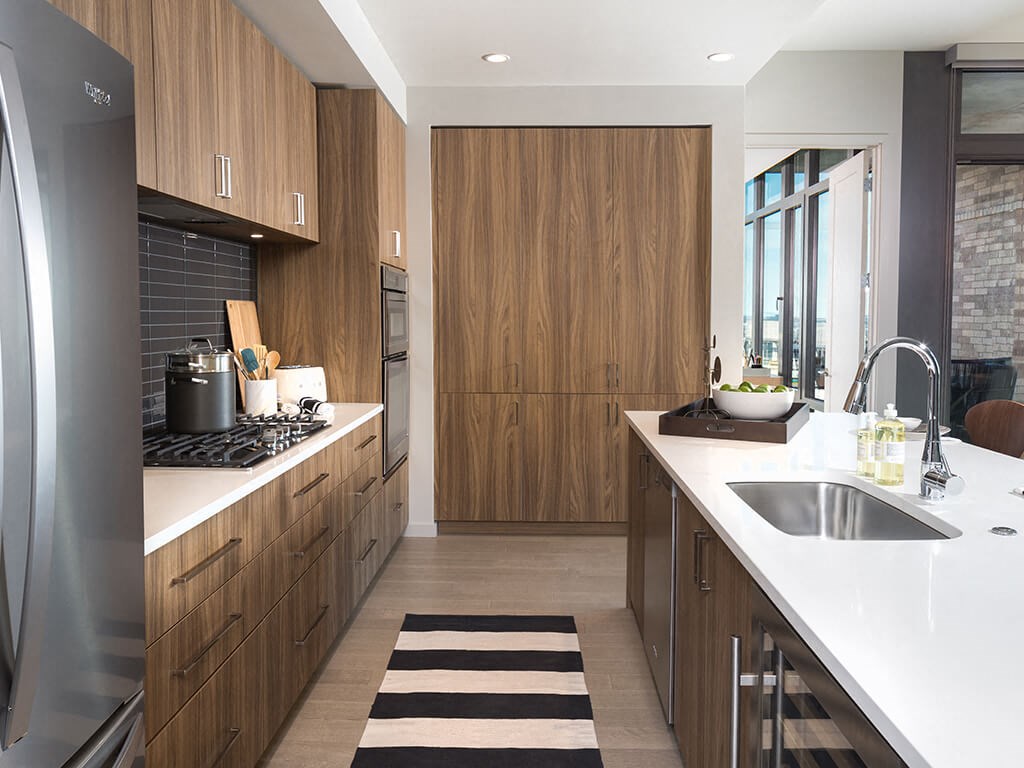 a kitchen with wooden cabinets and white counter tops