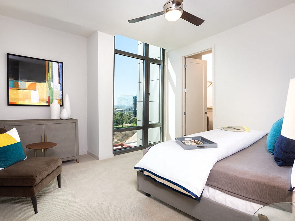 a bedroom with a bed and a ceiling fan