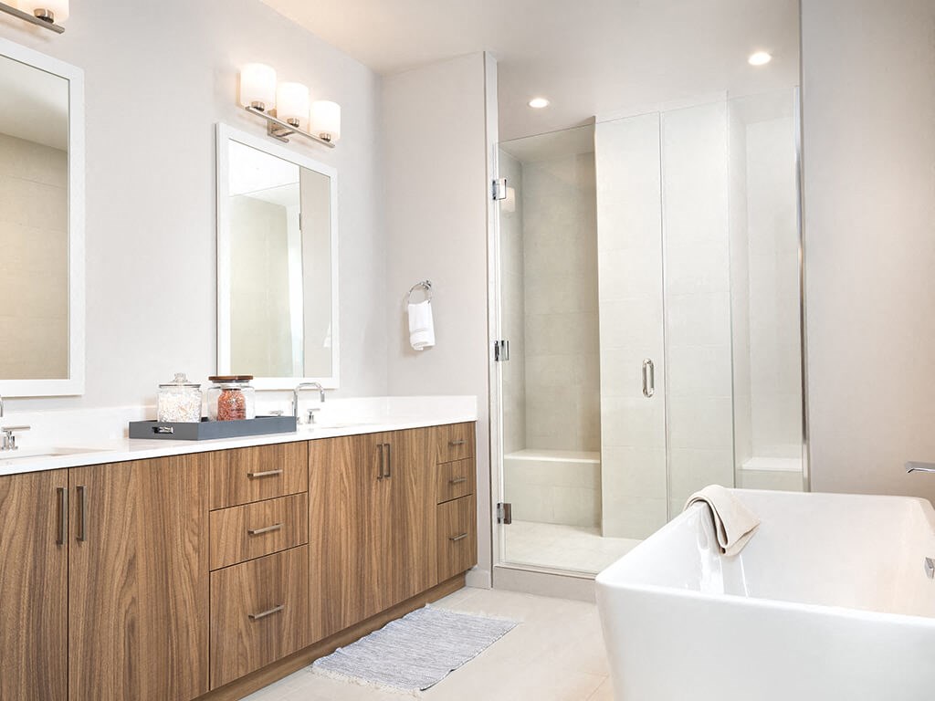 a bathroom with a tub and a sink and a mirror