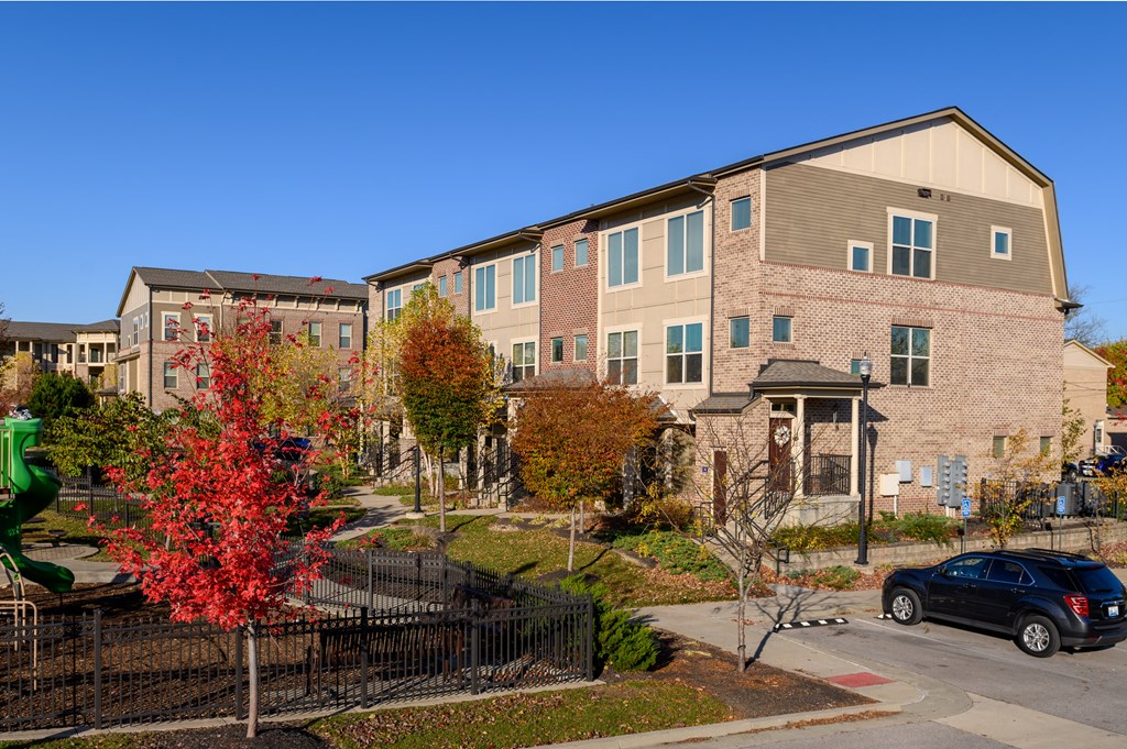 an apartment building with a car parked in front of it