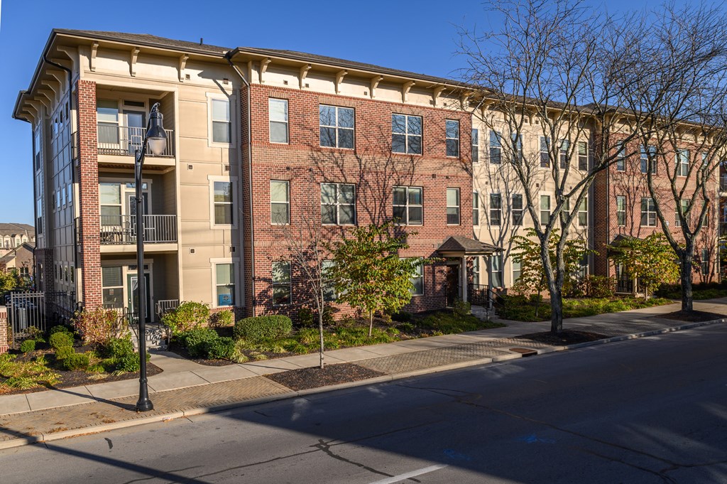 a red brick apartment building on a city street