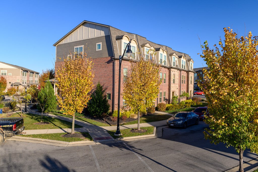 a brick apartment building with a street in front of it