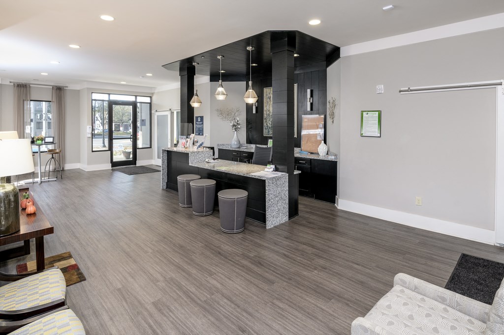 an open kitchen and living room with a bar and seating area