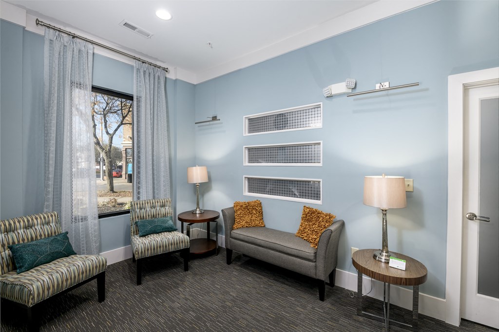 a living room with couches and chairs and a window