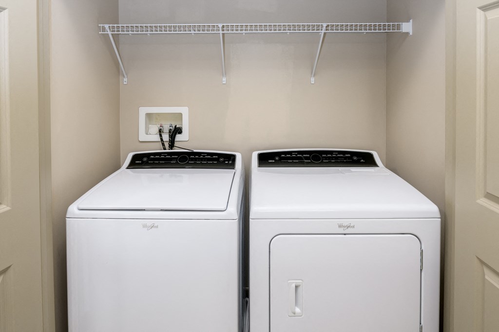 two washers and dryers in the laundry room of a home