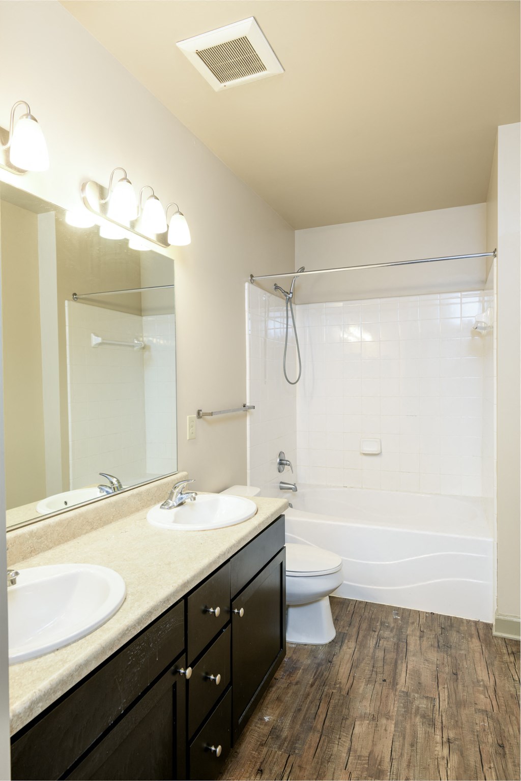 a bathroom with a toilet sink and shower and a mirror