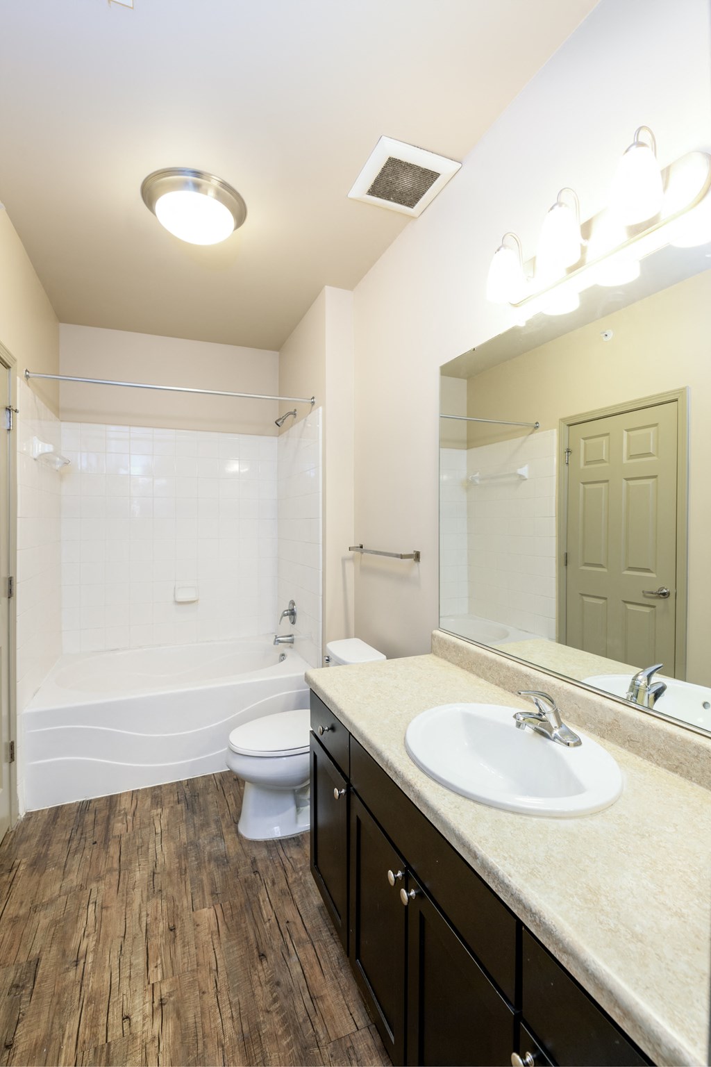 a bathroom with a sink and a toilet and a mirror