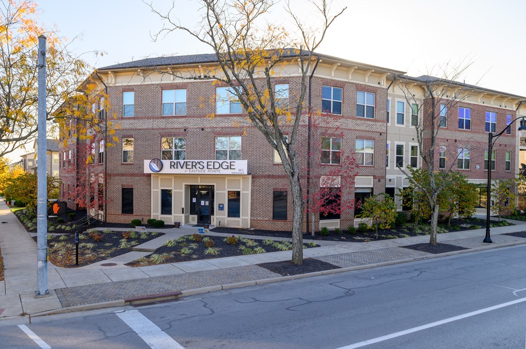 an apartment building on the corner of a street