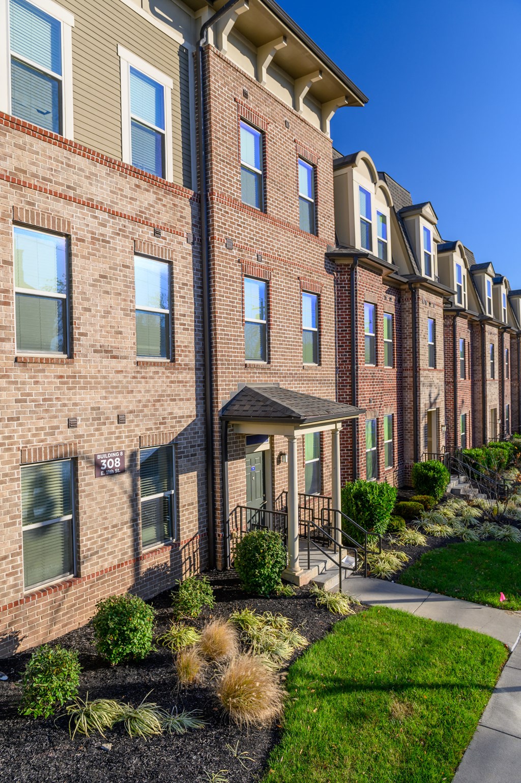 a brick building with a sidewalk in front of it