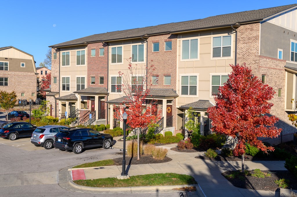 an apartment building with cars parked in front of it