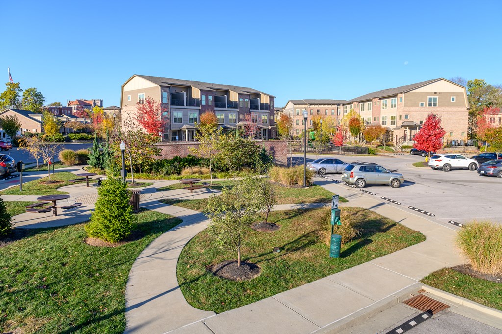 an aerial view of an apartment complex with a parking lot