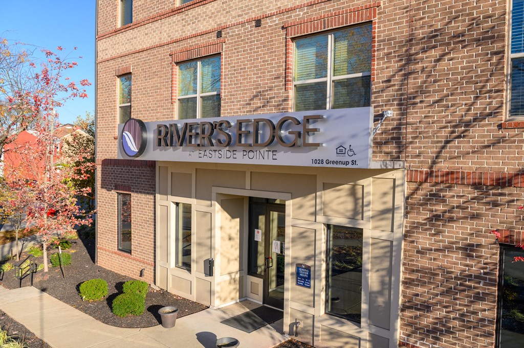 a brick building with a sign that reads rivers edge lease point