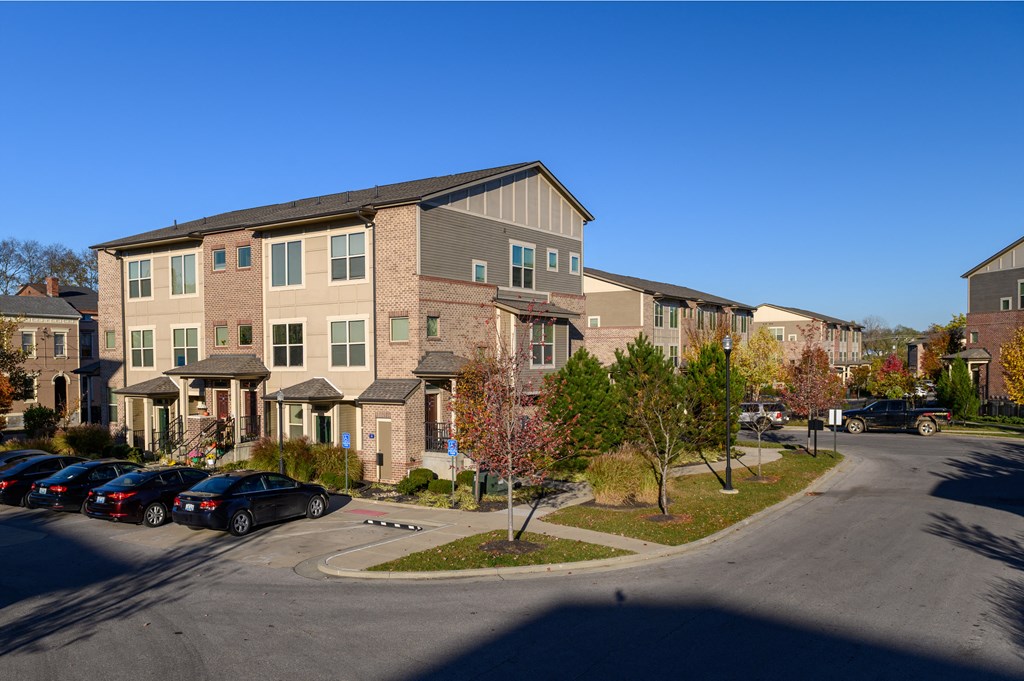 an empty parking lot in front of an apartment building