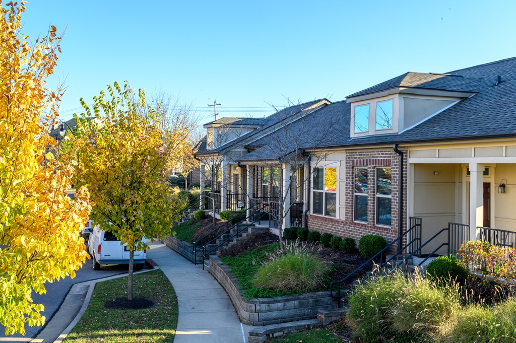 a row of houses on a street with a car in front of them