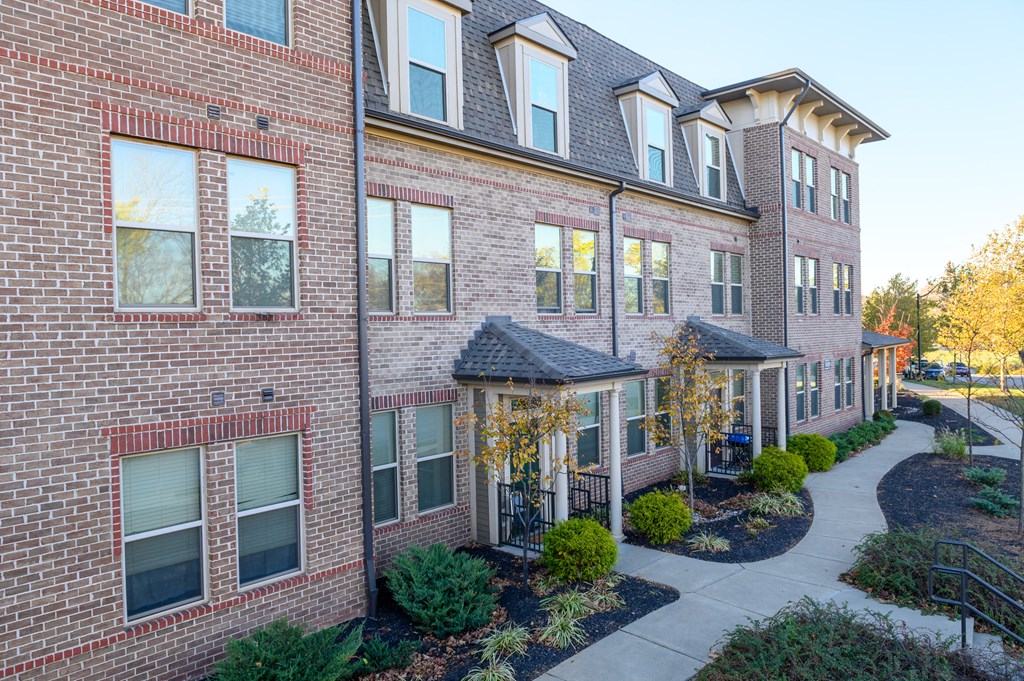 a brick building with a sidewalk in front of it