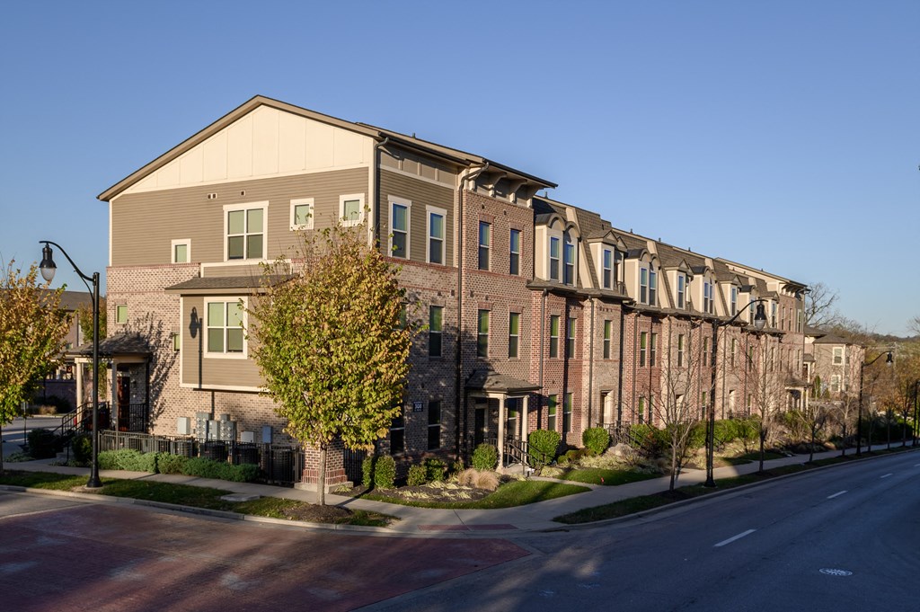 an apartment building with a street in front of it