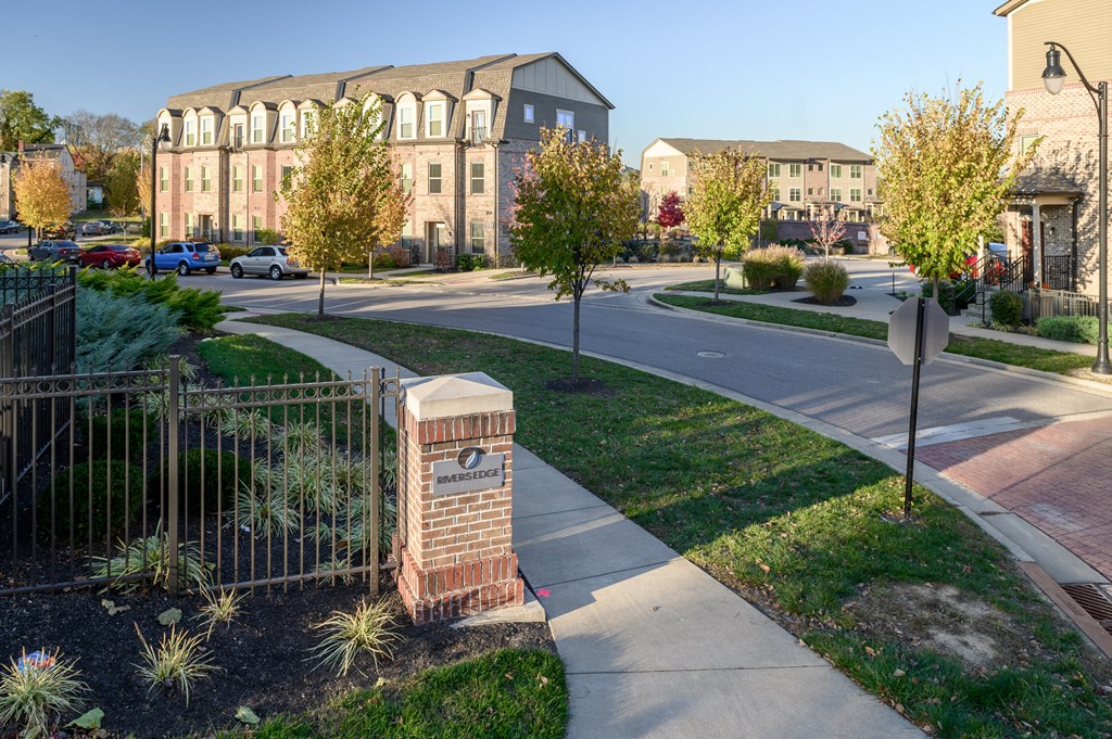 a city street with a building in the background and a sidewalk