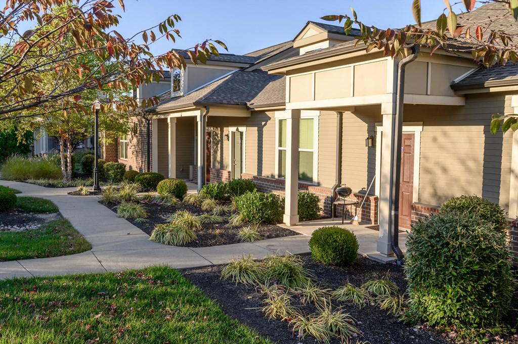 a row of houses with a sidewalk in front of them