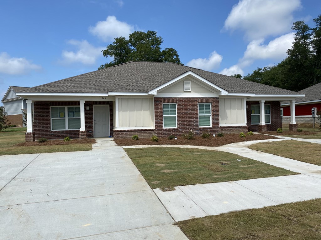 a house with a sidewalk in front of it