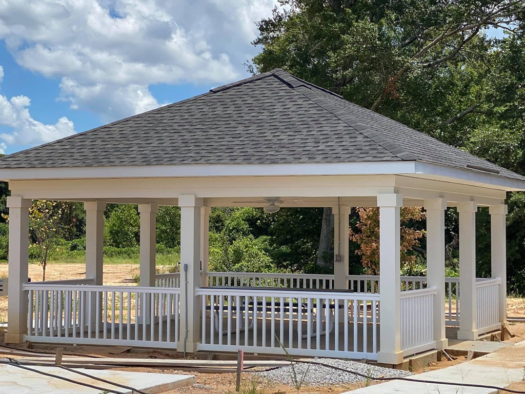 a gazebo is being constructed in the backyard of a house