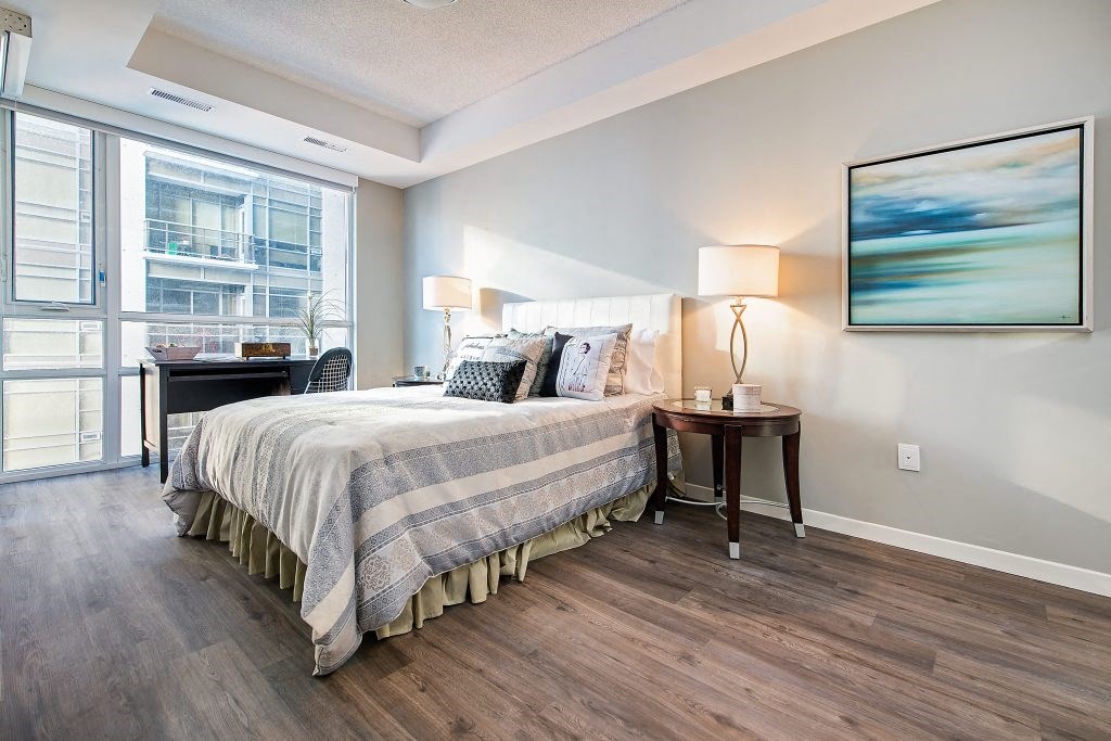 a bedroom with a bed and a window