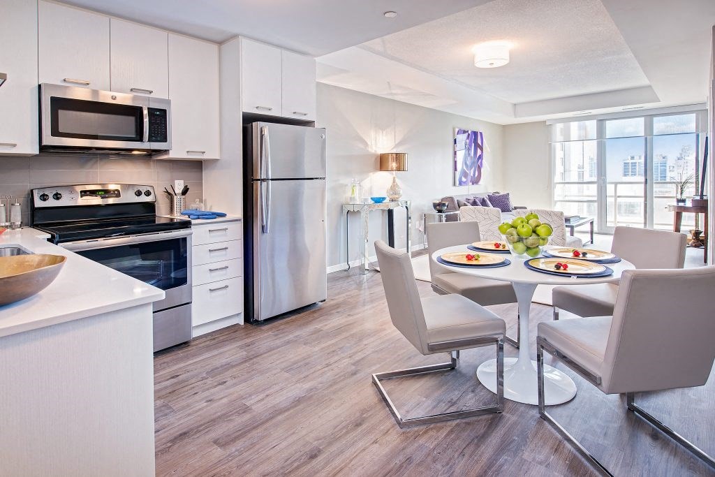 a kitchen and dining room with a table and chairs