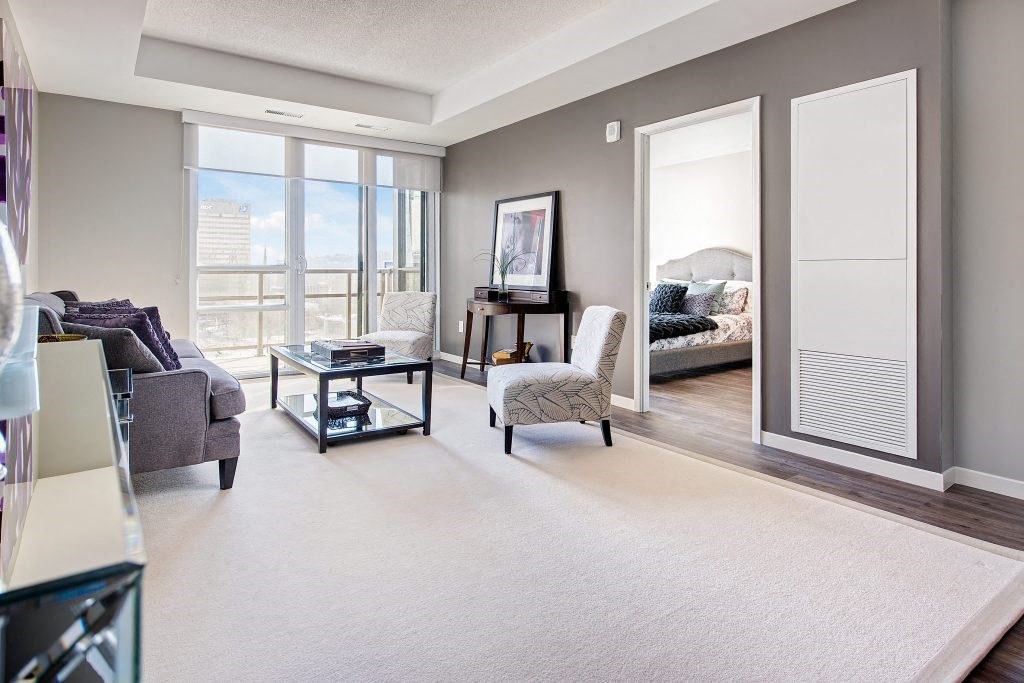 a living room with a view of a bedroom