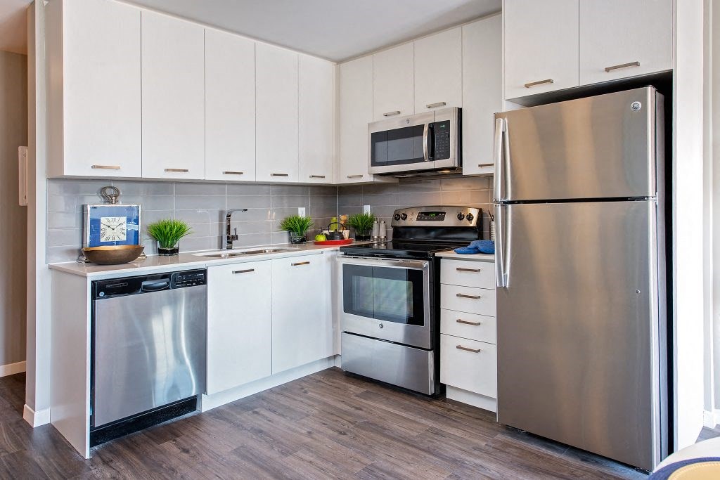 a kitchen with stainless steel appliances and white cabinets