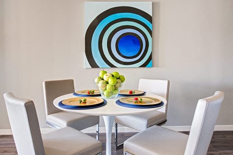 a dining room with a table and chairs
