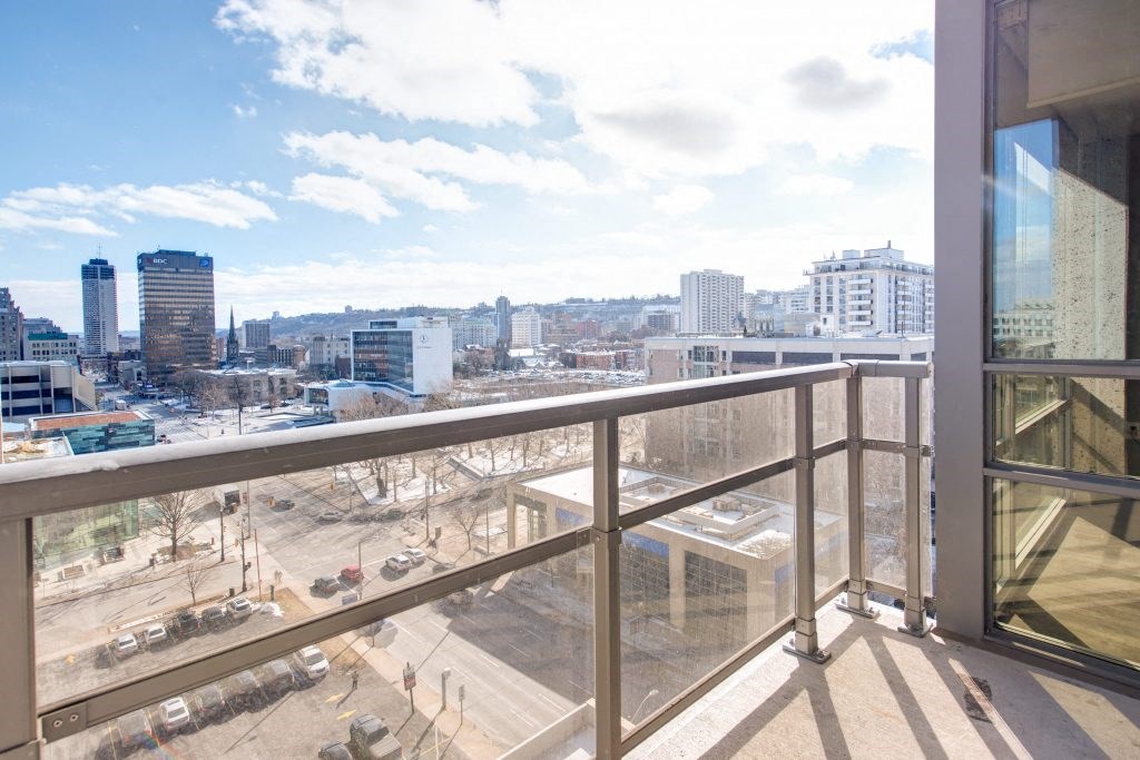 a view of the city from the balcony of a condominium