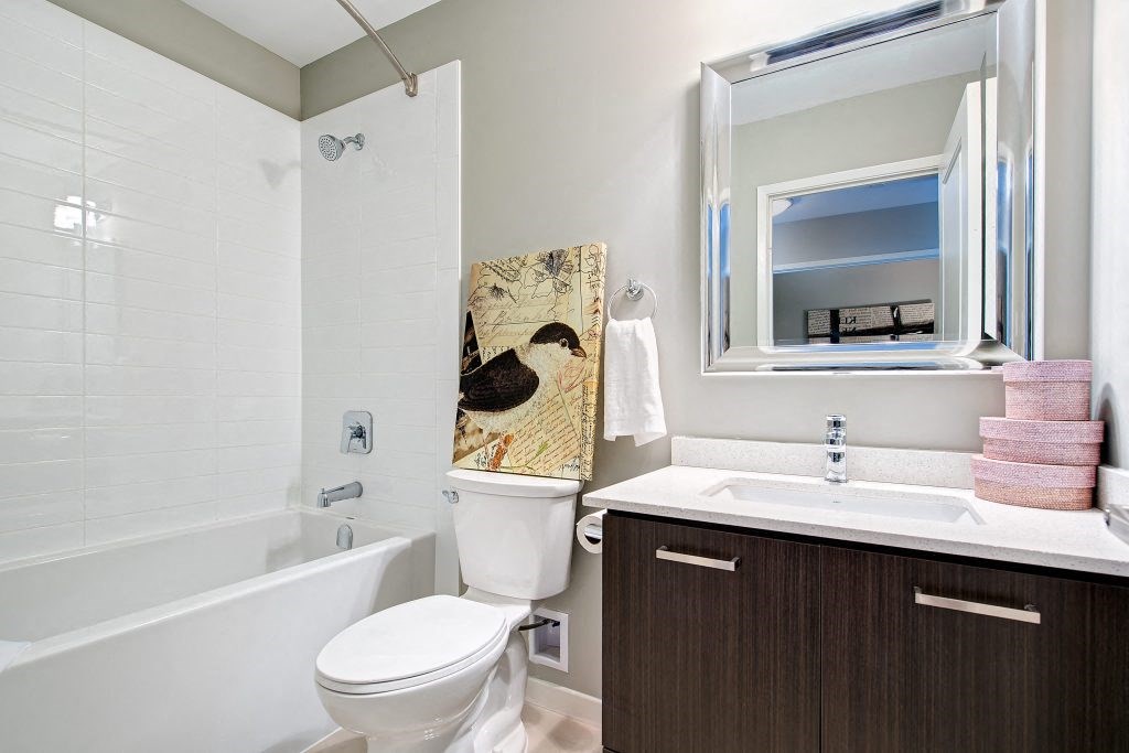a bathroom with a toilet sink and a bath tub
