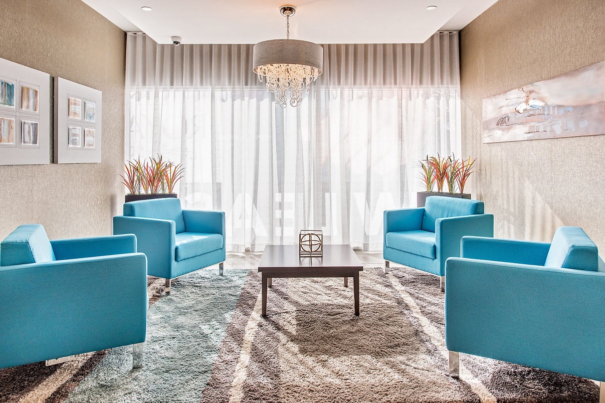 a living room with blue chairs and a table