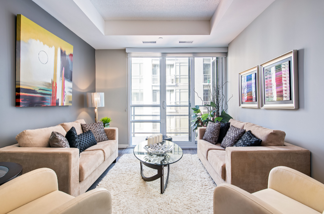 a living room with two couches and a glass coffee table