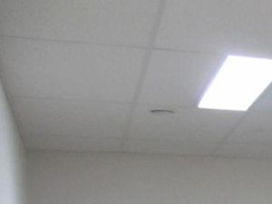 a gym with several pieces of exercise equipment and a wall mounted tv