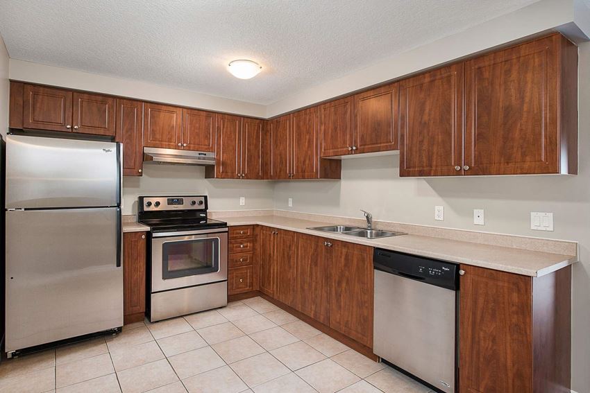 a kitchen with stainless steel appliances and wooden cabinets
