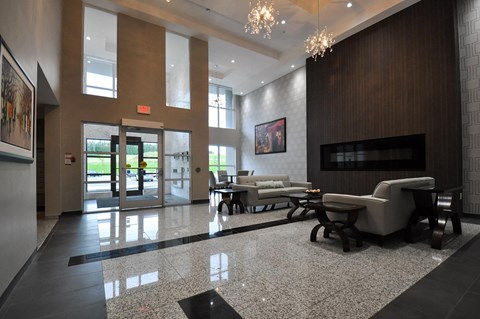 a lobby with couches and chairs and a fireplace