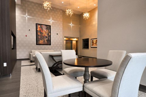 a dining room with white chairs and a table